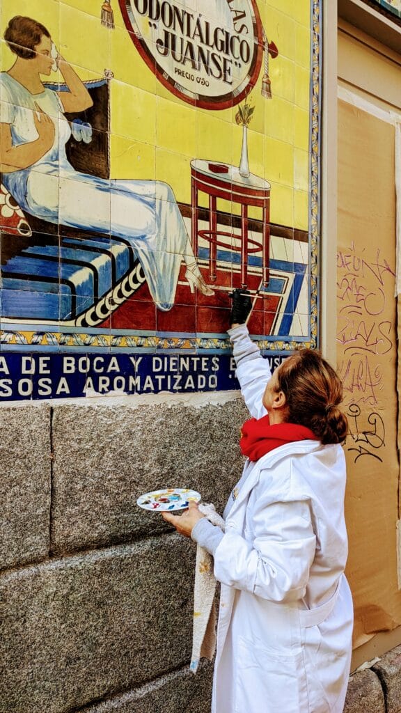 Restorer touches out the iconic Farmacia Juanse tilework