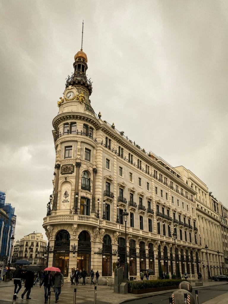View of a historic building with clock tower in Madrid, ideal for travel and architecture themes.