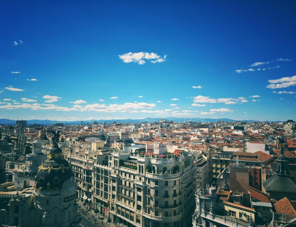 A breathtaking aerial view of Madrid's vibrant cityscape under a clear blue sky.